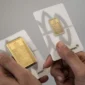 Karyawan menunjukkan sampel emas batangan di Butik Emas Logam Mulia PT. Aneka Tambang (ANTAM), Semarang, Jawa Tengah. 
